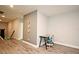 Hallway with gray walls, laminate flooring, trim, and a desk with a rolling chair near an accent wall at 3237 Palatka St, Orlando, FL 32824