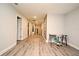 Hallway with durable laminate flooring, gray walls, a staircase, and a desk with a rolling chair near an accent wall at 3237 Palatka St, Orlando, FL 32824