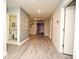 Well-lit hallway with wood-look flooring, leading to a bathroom and theater room at 3237 Palatka St, Orlando, FL 32824