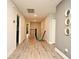 A hallway featuring durable laminate flooring, gray walls, a staircase, and doors leading to other rooms in the home at 3237 Palatka St, Orlando, FL 32824