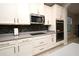 Modern kitchen appliances, including a stainless steel microwave and double oven, set against mosaic tile backsplash at 3237 Palatka St, Orlando, FL 32824