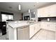 Well-lit kitchen counter with stainless steel appliances, white cabinetry, and open concept design at 3237 Palatka St, Orlando, FL 32824