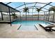 Inviting screened-in pool area with sun loungers, palm trees, and spa for ultimate relaxation at 3237 Palatka St, Orlando, FL 32824