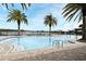 Community pool features a beach entry, palm trees, and lake view for Gathering relaxation and enjoyment at 3237 Palatka St, Orlando, FL 32824