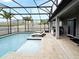 Expansive screened-in pool area with ample lounge space, outdoor kitchen and in-pool spa at 3237 Palatka St, Orlando, FL 32824