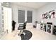 Salon setup featuring a styling chair, shelving units, and large window with modern blinds at 3237 Palatka St, Orlando, FL 32824