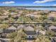 An aerial view showcasing the community's buildings with mature tree coverage and lakeside apartment homes at 3403 Greenwich Village Blvd # 104, Orlando, FL 32835