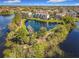 Aerial shot of a scenic pond and lakeside community with lush landscaping and waterside amenities at 3403 Greenwich Village Blvd # 104, Orlando, FL 32835