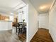 Adjacent to the kitchen, an open dining area is enhanced by wood floors and modern lighting fixtures at 3403 Greenwich Village Blvd # 104, Orlando, FL 32835