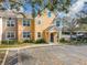 Attractive townhouse featuring a well-manicured lawn, ample parking, and appealing architectural details at 3403 Greenwich Village Blvd # 104, Orlando, FL 32835
