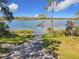 Beautiful lakeside scenery, with clear blue waters and a serene path leading to the shore at 3403 Greenwich Village Blvd # 104, Orlando, FL 32835