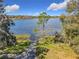 Picturesque lake view with a walkway leading to the water and natural landscaping at 3403 Greenwich Village Blvd # 104, Orlando, FL 32835
