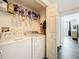 Functional laundry room with washer, dryer, and storage shelves at 3403 Greenwich Village Blvd # 104, Orlando, FL 32835