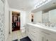 Bright main bathroom with dual sinks, white cabinets, and walk-in closet for added convenience and space at 3403 Greenwich Village Blvd # 104, Orlando, FL 32835