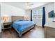 Comfortable main bedroom with wood floors, ceiling fan and bright window creating a relaxing retreat at 3403 Greenwich Village Blvd # 104, Orlando, FL 32835