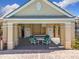 Outdoor patio area features a table and chairs, perfect for relaxing or entertaining guests at 3403 Greenwich Village Blvd # 104, Orlando, FL 32835