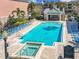 Community pool area featuring lounge chairs and mature landscaping at 3403 Greenwich Village Blvd # 104, Orlando, FL 32835