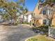View of street with well-kept townhouses, nice landscaping, and convenient parking at 3403 Greenwich Village Blvd # 104, Orlando, FL 32835