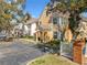 Nice street view of townhouses featuring well-maintained landscaping and convenient parking at 3403 Greenwich Village Blvd # 104, Orlando, FL 32835