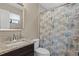 Bathroom featuring a single vanity with granite counters and a seashell themed shower curtain at 3509 S Saint Lucie Dr, Casselberry, FL 32707