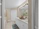 Bright bathroom featuring a double vanity, large mirror, and a separate bathtub and shower at 3509 S Saint Lucie Dr, Casselberry, FL 32707