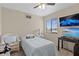 Bedroom with a bed, desk, and tv near a bright window at 3509 S Saint Lucie Dr, Casselberry, FL 32707