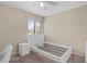 Bedroom featuring a bed frame, small white nightstand and a window with blinds at 3509 S Saint Lucie Dr, Casselberry, FL 32707