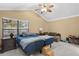 Spacious bedroom with vaulted ceilings, fan, and ample natural light, showcasing a comfortable retreat at 3509 S Saint Lucie Dr, Casselberry, FL 32707