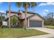 Inviting two-story home with a large garage, mature landscaping, and a well-maintained front lawn at 3509 S Saint Lucie Dr, Casselberry, FL 32707