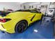 A sleek yellow sports car is parked on a glossy blue floor inside the garage at 3509 S Saint Lucie Dr, Casselberry, FL 32707