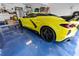 A sleek yellow sports car parked on a glossy blue floor inside the garage at 3509 S Saint Lucie Dr, Casselberry, FL 32707