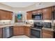 Charming kitchen with granite counters, stainless steel appliances and view to living area at 3509 S Saint Lucie Dr, Casselberry, FL 32707