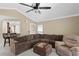 Comfortable living room featuring tile floors, a ceiling fan, and sectional seating at 3509 S Saint Lucie Dr, Casselberry, FL 32707