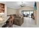 Spacious living room with tile flooring, comfortable seating, and sliding door access to the lanai at 3509 S Saint Lucie Dr, Casselberry, FL 32707