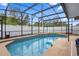 Beautiful in-ground swimming pool surrounded by a screened enclosure, offering a private oasis at 3509 S Saint Lucie Dr, Casselberry, FL 32707