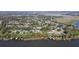 Aerial view of a waterfront property featuring lush trees and mature landscaping at 35624 Cypress Ct, Leesburg, FL 34788