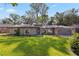 Charming single-story home features arched windows, a well-manicured lawn, and lush landscaping at 35624 Cypress Ct, Leesburg, FL 34788