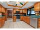 The kitchen has stainless steel appliances, wooden cabinets, and a large window at 35624 Cypress Ct, Leesburg, FL 34788