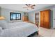 Main bedroom with large windows overlooking the water and an ensuite bathroom at 35624 Cypress Ct, Leesburg, FL 34788