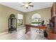 Bright home office with large windows, tile floors, and a spacious desk at 35624 Cypress Ct, Leesburg, FL 34788