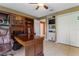 Home office with a large desk, built in bookcases, and tile floors at 35624 Cypress Ct, Leesburg, FL 34788