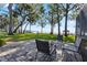Stone patio with outdoor seating offering great views of the lake, gazebo and property at 35624 Cypress Ct, Leesburg, FL 34788