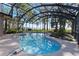Enjoy this covered pool with screened enclosure, complemented by water view and garden at 35624 Cypress Ct, Leesburg, FL 34788