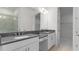 Modern bathroom featuring double vanity, grey countertops, and a walk-in shower at 4192 Barbuda Ln, Kissimmee, FL 34758