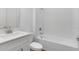 Bright bathroom features a tub with white tiled shower at 4192 Barbuda Ln, Kissimmee, FL 34758