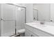 Well-lit bathroom featuring glass enclosed shower, white vanity, and ample counter space at 4192 Barbuda Ln, Kissimmee, FL 34758