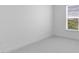 Neutrally decorated bedroom with carpet floors and a window offering outdoor views at 4192 Barbuda Ln, Kissimmee, FL 34758