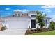Charming, modern white home with a two car garage, neat landscaping, and a welcoming entrance at 4192 Barbuda Ln, Kissimmee, FL 34758