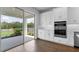 Modern kitchen showcasing stainless appliances, white cabinets, and sliding glass door to patio at 4192 Barbuda Ln, Kissimmee, FL 34758