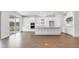 Bright, open kitchen with white cabinets, stainless steel appliances, large island, and sliding glass doors at 4192 Barbuda Ln, Kissimmee, FL 34758